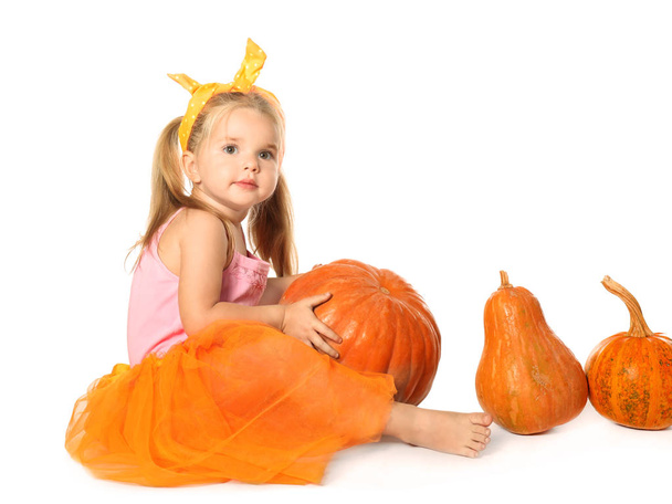 Adorable little girl with pumpkins  - Foto, afbeelding