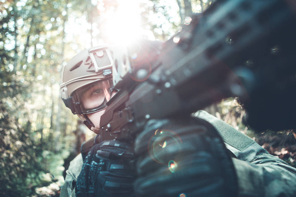 Image of military man in helmet and with submachine gun - Photo, image