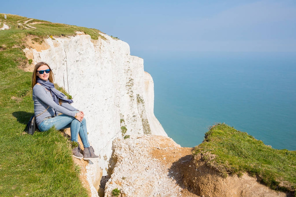 Girl sitting at the edge of the white cliff of Dover - Zdjęcie, obraz