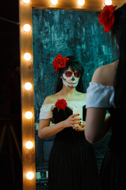 Photo of zombie woman with white face with red flower on her head - Фото, изображение