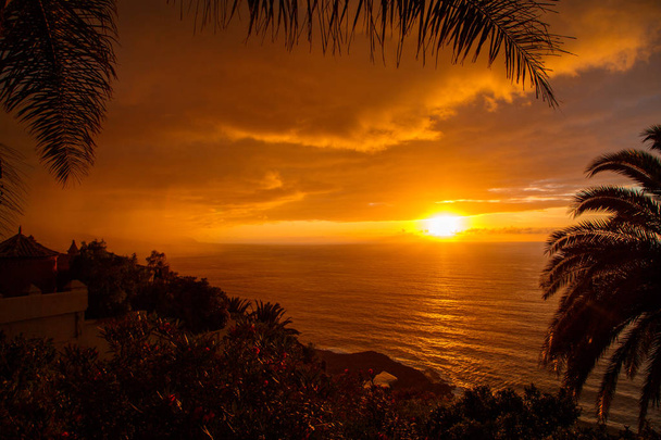 Amazing orange sunset view by the Atlantic ocean on Canary island - 写真・画像