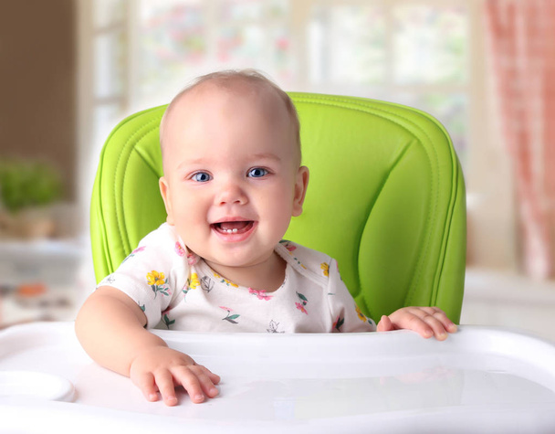 Baby sitting at empty table.Nutrition concept. - Фото, зображення