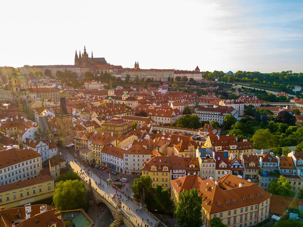 Beautiful aerial sunset view of the Prague city panoramic view with a castle on the horizon from above. Amazing city landscape by the Vltava river in the middle of the city. - Valokuva, kuva