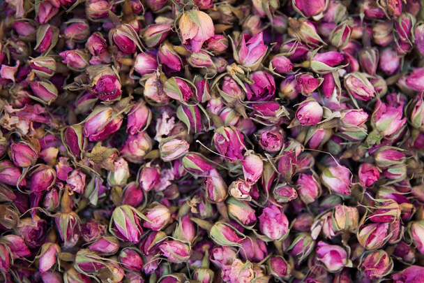 Dried rosebuds background texture closeup. Pink rosebud macro close up of heap. - Photo, Image
