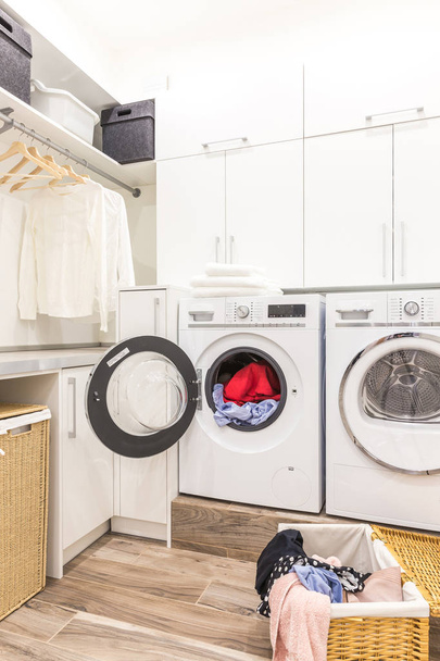 Laundry room with basket and dirty clothes - Photo, Image