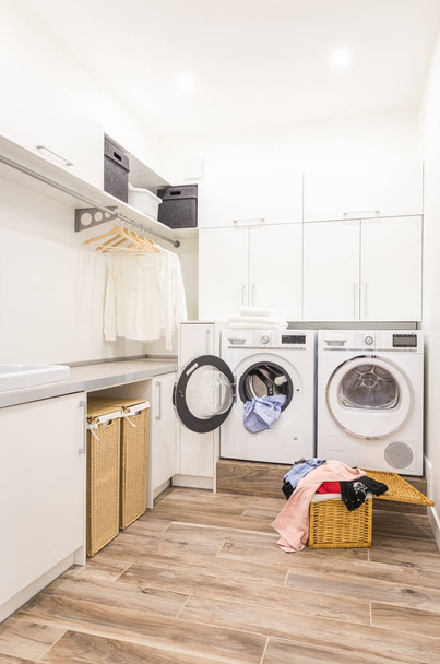 Laundry room with basket and dirty clothes - Photo, Image