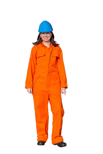 Woman worker in orange overall and blue safety helmet isolated on white background - Photo, Image