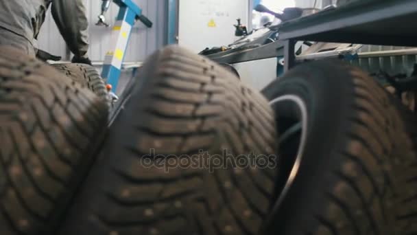 A lot of luxury tires in car service for repairing - mechanical workshop - Footage, Video