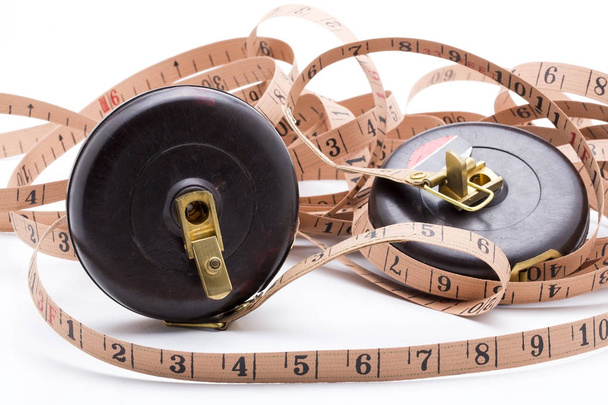 Old tape measure on white background - Foto, afbeelding
