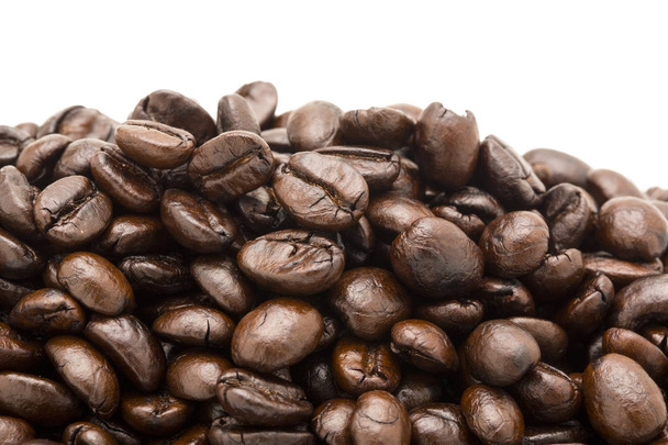 Closeup of coffee beans with focus on one - Fotoğraf, Görsel