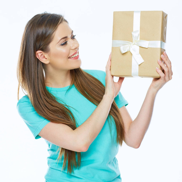 Happy woman with long hair in blue t-shirt holding gift box   - Foto, Imagen