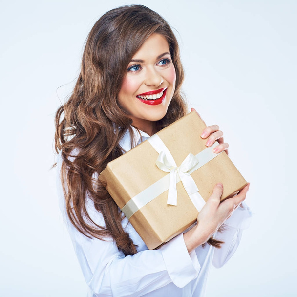 Smiling businesswoman in white shirt with long curly hair holding gift box  - Foto, immagini