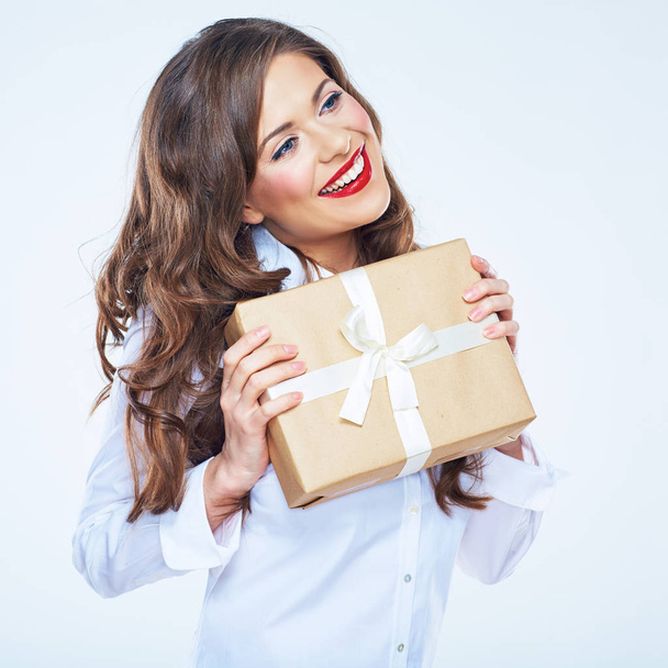 Smiling businesswoman in white shirt with long curly hair holding gift box  - Фото, изображение