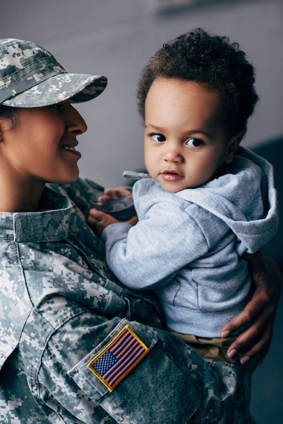 mother in military uniform with little son - Foto, immagini