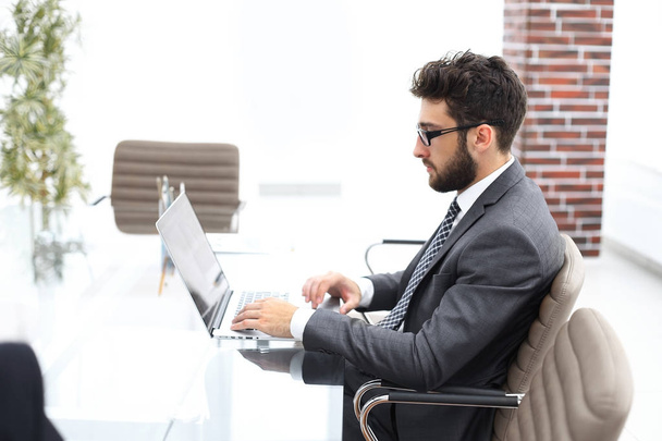 businessman working in bright office, sitting at desk - Φωτογραφία, εικόνα