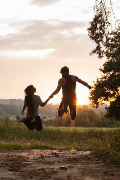 Romance couple jump together nature concept. - Foto, afbeelding