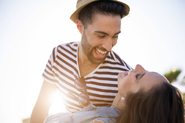 Happy man holding his girlfriend down laughing - Photo, image
