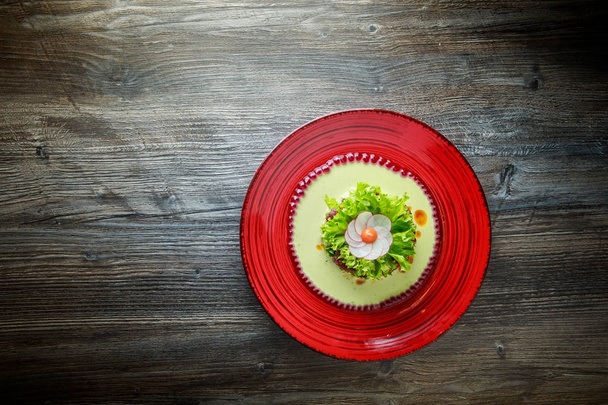 Healthy salad with meat and flower decoration made from radish on red plate - Photo, Image