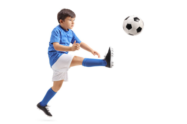 soccer player kicking a football in mid-air - Fotó, kép