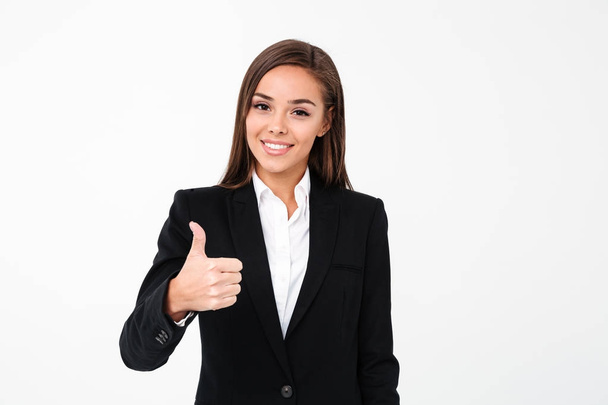 Pretty cheerful business woman showing thumbs up - Фото, изображение