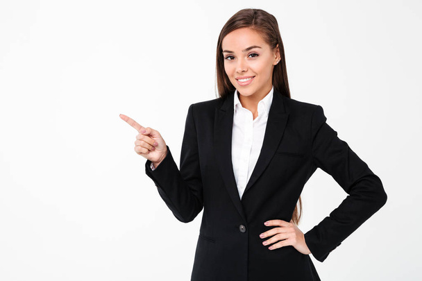 Happy business woman pointing to copyspace. - Foto, Imagem