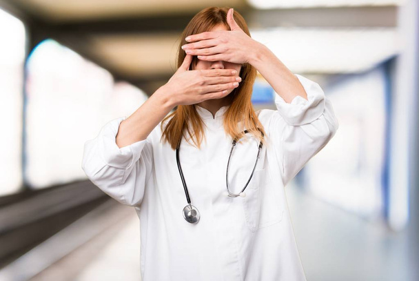 Young doctor woman covering her face in the hospital - Photo, Image
