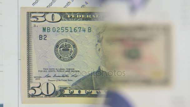 Consider a banknote of fifty dollars, an increase with a magnifying glass. - Filmmaterial, Video