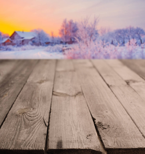 rustic wooden table and winter landscape - Foto, afbeelding