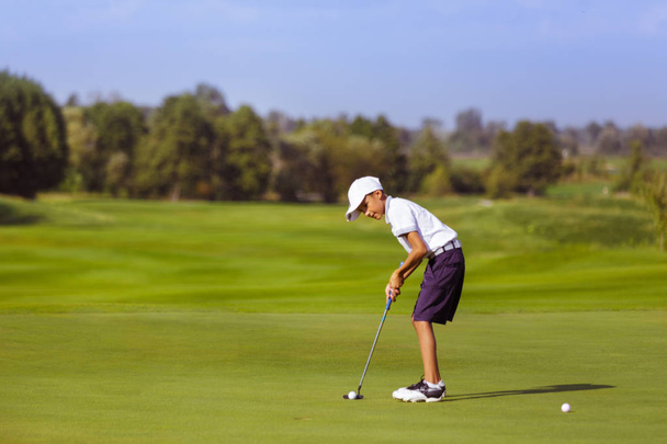 niño jugando al golf
 - Foto, Imagen