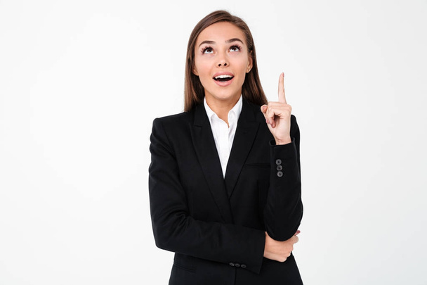 Happy business woman pointing to copyspace. - Foto, Imagen
