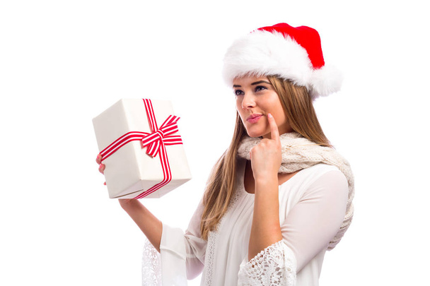 Young woman holding a Christmas gift  - Foto, Bild