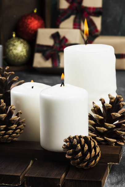 Burning candles and Christmas attributes on a dark background - Photo, image
