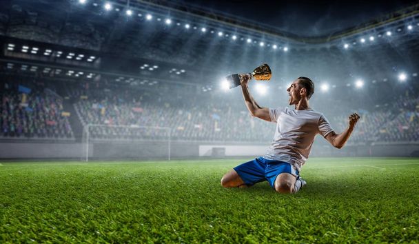 Soccer player at stadium. Mixed media - Фото, изображение