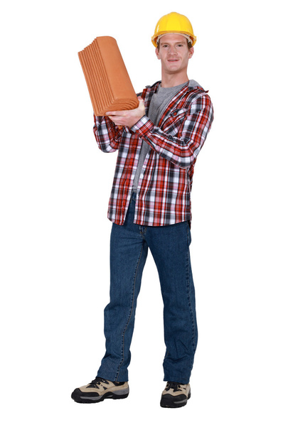 Tradesman holding terracotta shingles - Foto, afbeelding