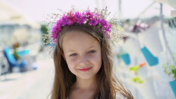 Little amazing girl with blue eyes smiling at camera on bright bay bar. 4K - Séquence, vidéo