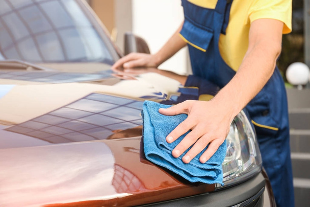 Man cleaning car with rag outdoors - Photo, image