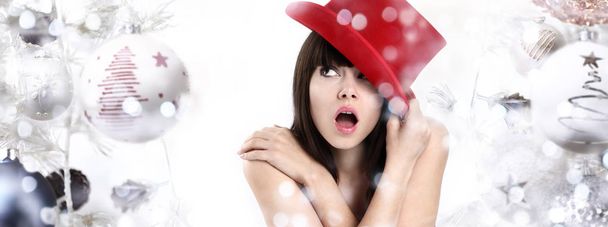 Wonderful woman surprised on Christmas background with balls and - Photo, Image