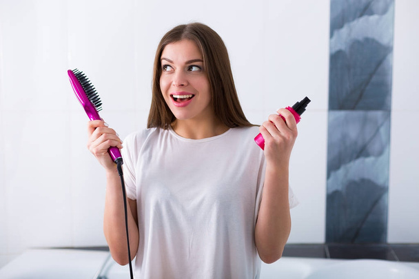 Woman with a hot straightening brush - Foto, Imagem