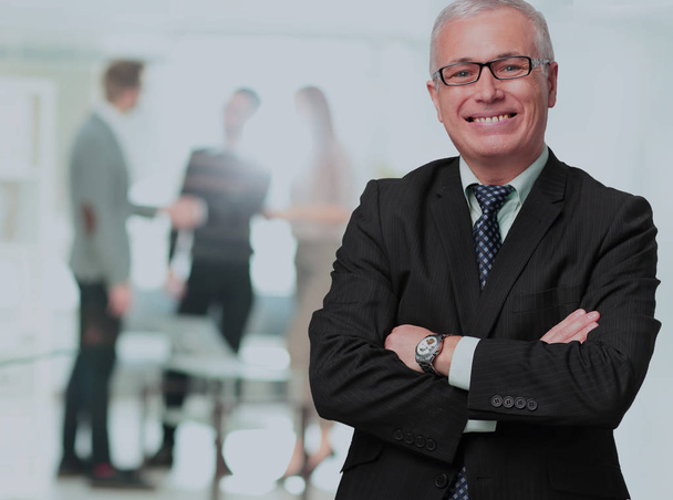 Happy mature business man looking at camera with satisfaction at office - Photo, Image