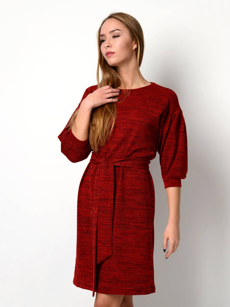 Young beautiful woman posing in new fashion red pattern winter dress - Foto, Imagen