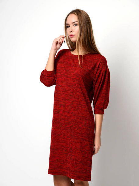 Young beautiful woman posing in new fashion red pattern winter dress - Foto, afbeelding