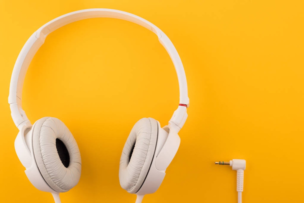 White headphones on a yellow background - Photo, Image