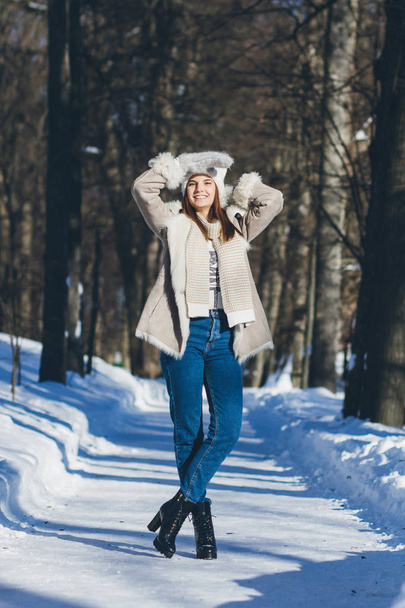 Girl in hat and mittens smiling in the winter - Valokuva, kuva