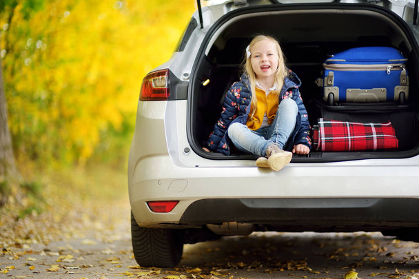 little girl in car trunk  - Фото, изображение
