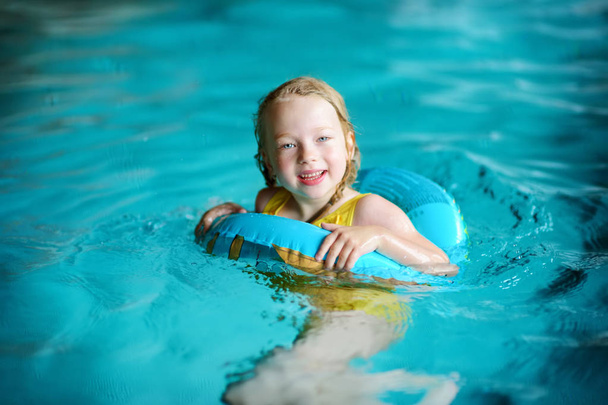 little girl swimming with inflatable ring  - Photo, image