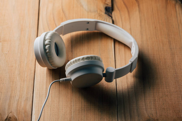 White headphones on wooden table - Photo, Image