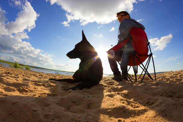 man on the beach with his dog - Фото, изображение