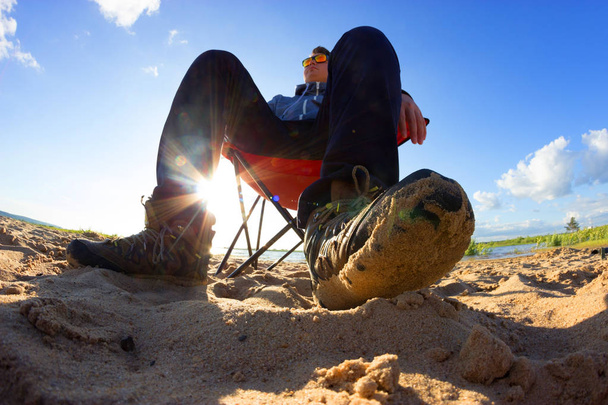 very self confident and arrogant men sit on the beach - Foto, Bild