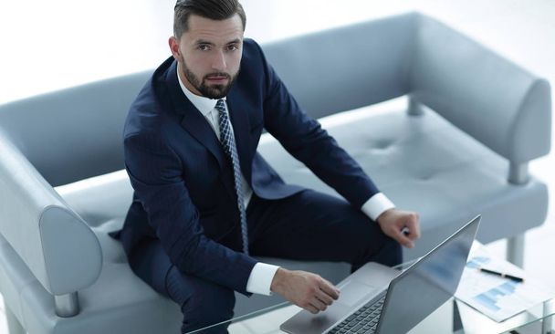 businessman working on a laptop with financial charts - Zdjęcie, obraz
