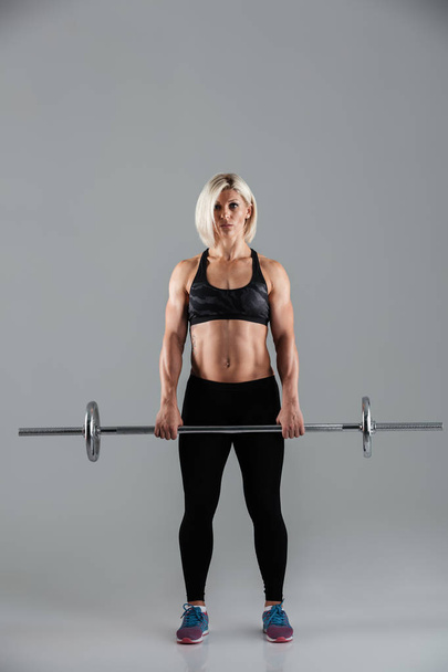 Full length portrait of a confident muscular adult woman - Fotografie, Obrázek